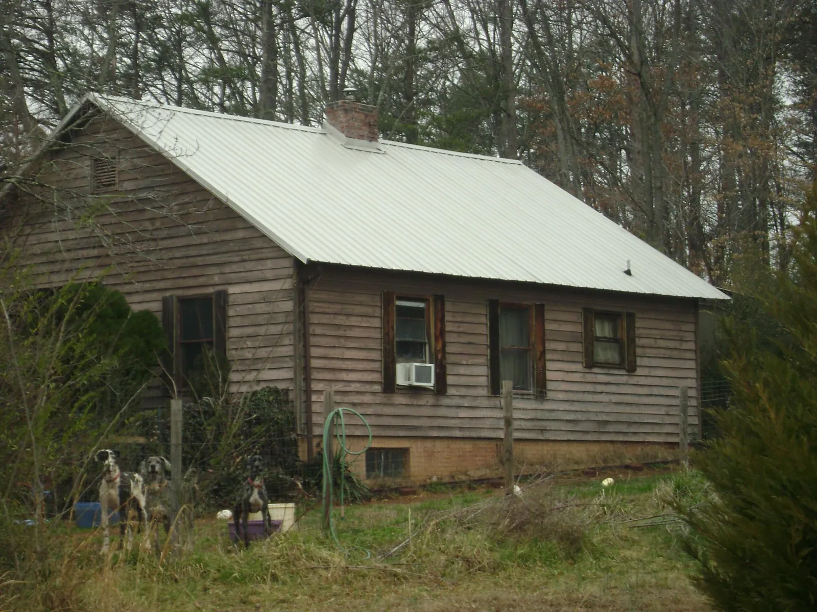 White metal roof on an old wood sided farmhouse, from a Metal Roof Installation job in Horton